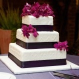 square cake with purple ribbon
