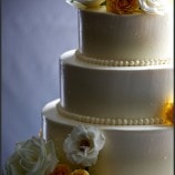 Simple dot wedding cake with yellow flowers