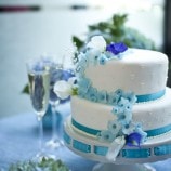 small wedding cake with blue flowers