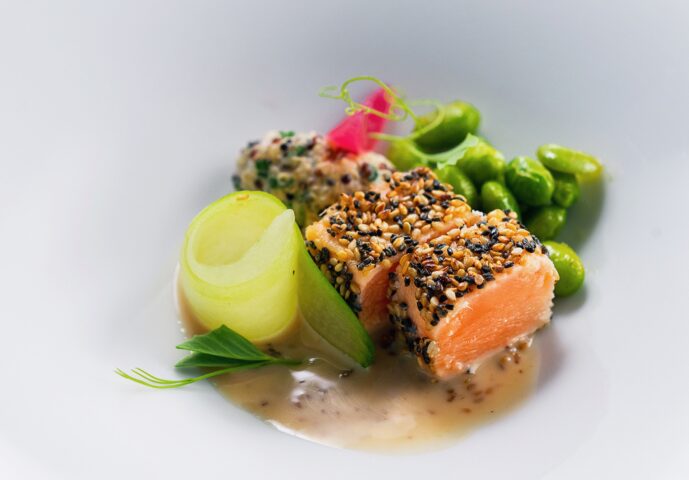 Salmon and vegetables topped with sesame seeds.