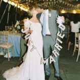 Under the tent with “Just Married” sign